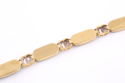 Lot 18 - An 18ct yellow gold, green jade, and diamond...