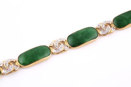Lot 18 - An 18ct yellow gold, green jade, and diamond...