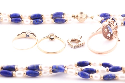 Lot 69 - A yellow metal and blue stone ring, the shank...