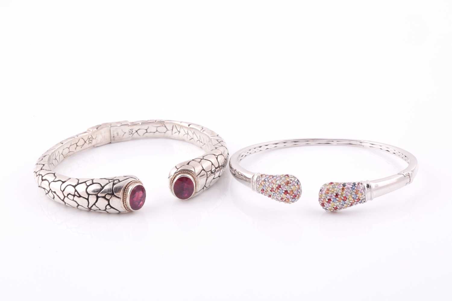 Lot 55 - A silver torque bangle, with a mixed oval-cut...