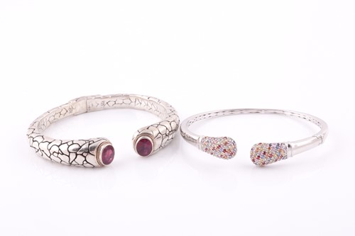 Lot 55 - A silver torque bangle, with a mixed oval-cut...