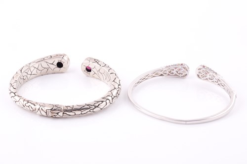 Lot 55 - A silver torque bangle, with a mixed oval-cut...