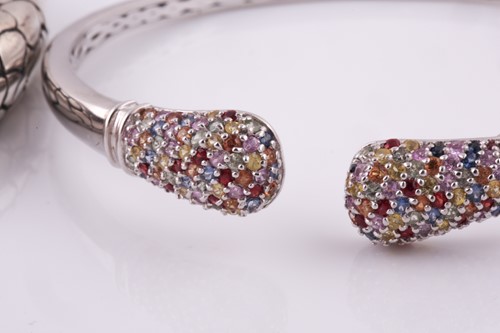 Lot 55 - A silver torque bangle, with a mixed oval-cut...