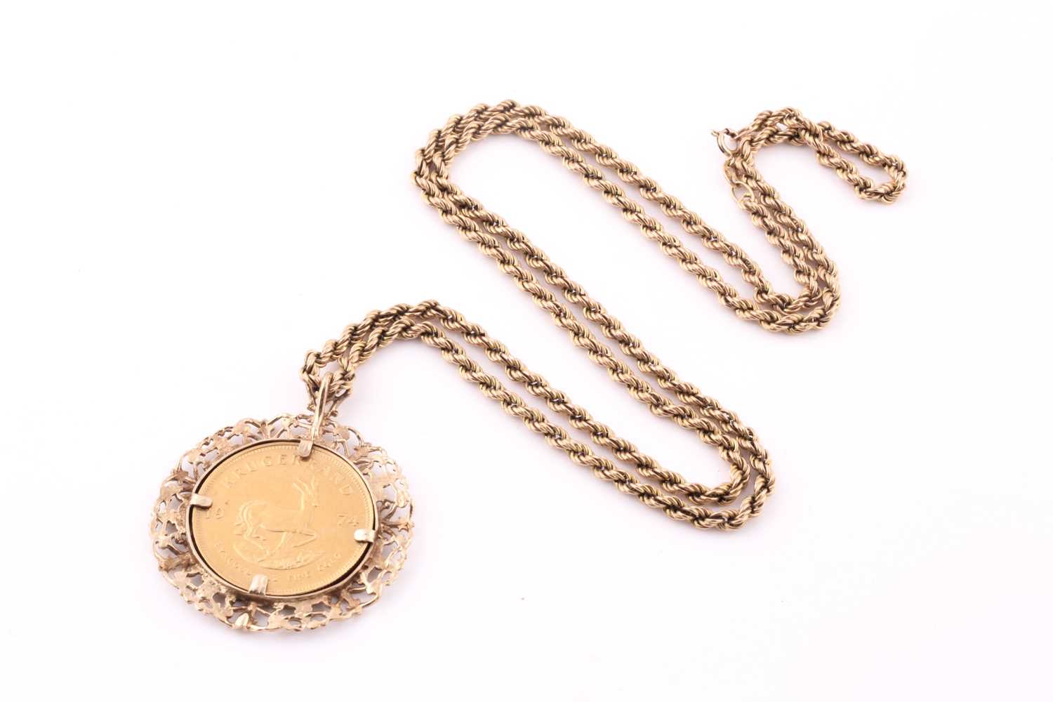Lot 21 - A Krugerrand pendant and ropetwist chain; the...