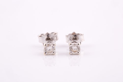 Lot 298 - A pair of solitaire diamond stud earrings, the...