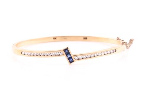 Lot 162 - A 14ct yellow gold, diamond, and sapphire...