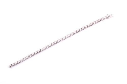 Lot 366 - An 18ct white gold and diamond tennis bracelet,...