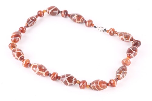 Lot 190 - A string of dark amber coloured Dzi type...