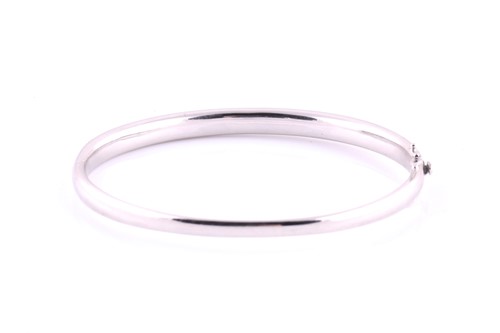 Lot 49 - A diamond set hinged bangle, pavé set with one...