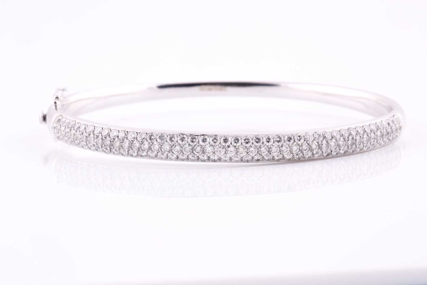 Lot 49 - A diamond set hinged bangle, pavé set with one...