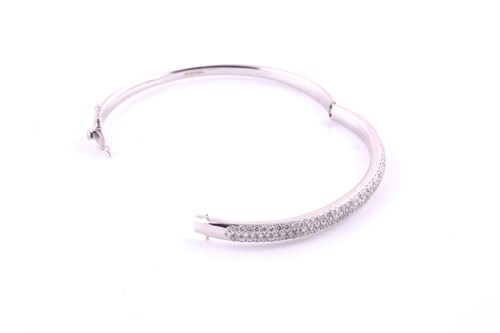 Lot 49 - A diamond set hinged bangle, pavé set with one...