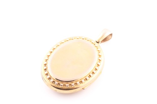 Lot 66 - A Victorian yellow metal oval-shaped locket...