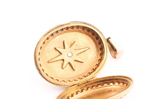 Lot 66 - A Victorian yellow metal oval-shaped locket...