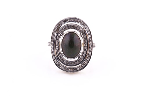 Lot 320 - An opal and diamond cluster ring set with an...
