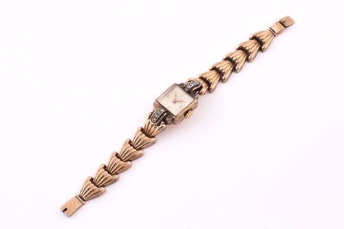 Lot 19 - A gold plated cocktail watch; the square...