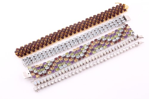 Lot 431 - An articulated garnet set gilded bracelet, the...