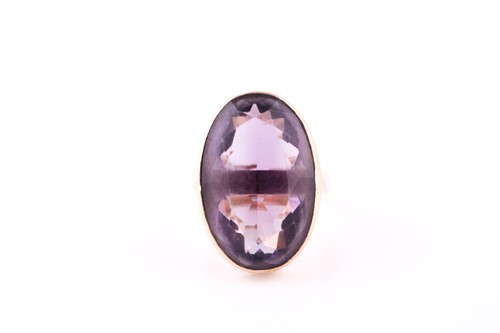 Lot 101 - A 9ct yellow gold and amethst dress ring, set...