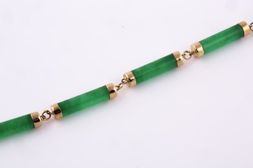 Lot 62 - A 14ct yellow gold and jade bracelet, the...