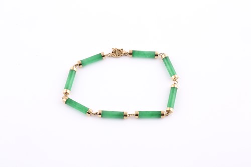 Lot 62 - A 14ct yellow gold and jade bracelet, the...
