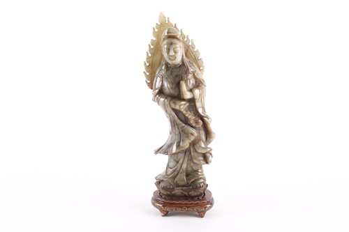 Lot 96 - A carved soapstone figure of Guanyin, on an...