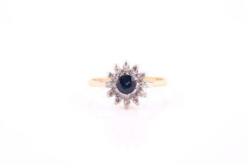 Lot 337 - A sapphire and diamond cluster ring, the round...