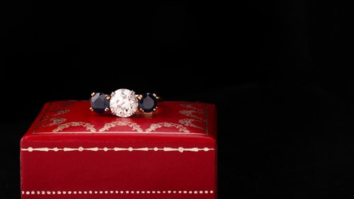 Lot 669 - A sapphire and diamond three-stone ring The...