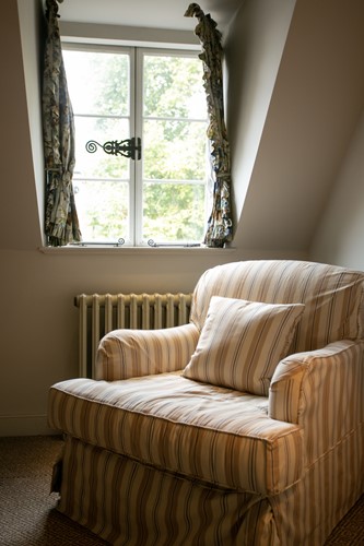 Lot 1 - An Edwardian style scroll back easy chair with...