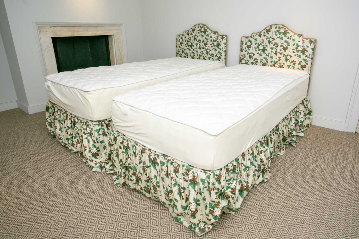 Lot 10 - A pair of floral chintz upholstered serpentine...