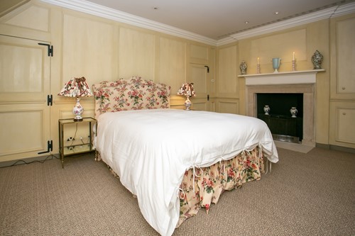 Lot 18 - A floral chintz upholstered serpentine topped...
