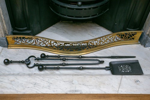 Lot 63 - A George III polished brass serpentine fire...