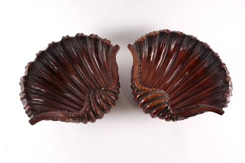 Lot 223 - A pair of carved wood clam shells, early 20th...