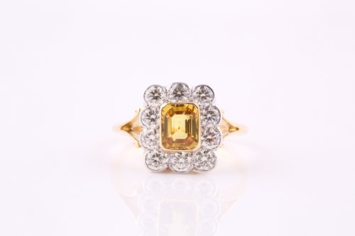 Lot 332 - A yellow sapphire and diamond cluster ring,...