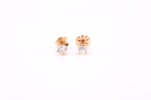 Lot 411 - Pair of diamond earrings, each with a round...