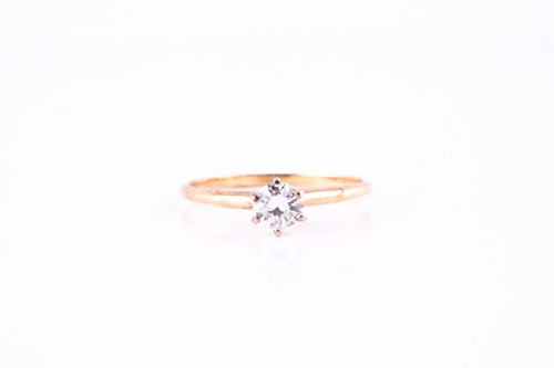 Lot 11 - A single-stone diamond ring, the round...