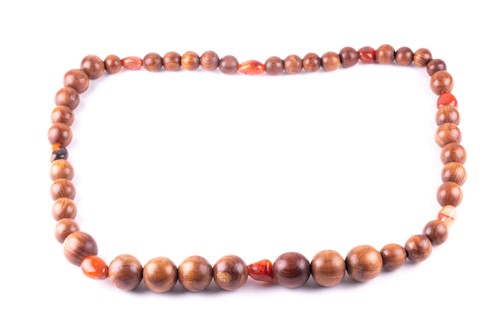 Lot 280 - A long Chanel necklace, the turned wooden...