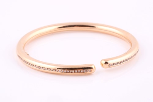 Lot 191 - A rose coloured and diamond set torque style...