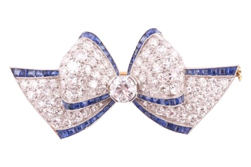 Lot 289 - An Art Deco sapphire and diamond bow brooch,...