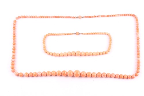 Lot 137 - Two early 20th century light-orange coral bead...