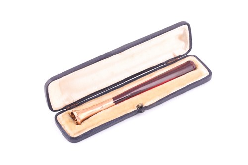 Lot 323 - A 9ct rose gold mounted cigarette holder,...
