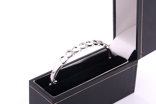 Lot 209 - A lot consisting of a silver bangle set with...