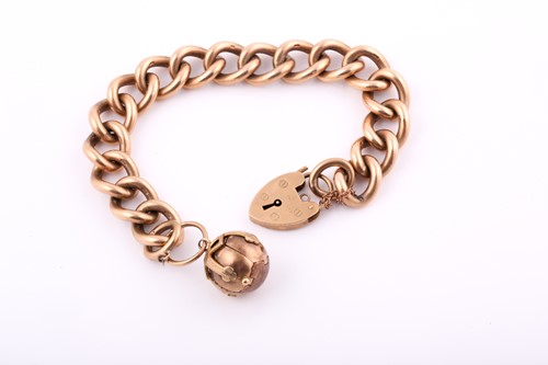 Lot 218 - A 9ct yellow gold charm bracelet, with heavy...