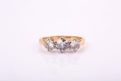 Lot 55 - An 18ct yellow gold three stone diamond ring,...