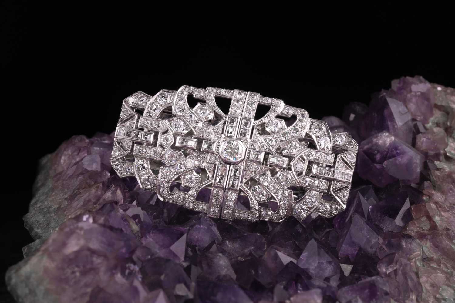 Lot 12 - An Art Deco diamond lapel brooch, the large...