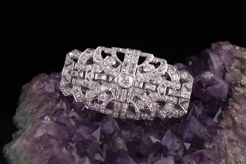 Lot 12 - An Art Deco diamond lapel brooch, the large...