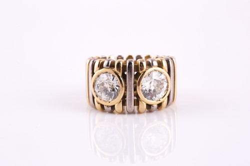 Lot 123 - A dual diamond dress ring, with two rub-over...