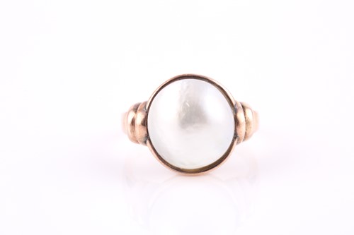 Lot 156 - A mabe pearl ring, the off-round 11.5-12mm...