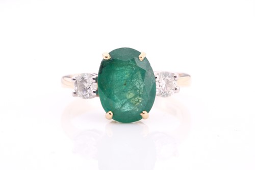 Lot 212 - A large emerald and diamond three stone ring...