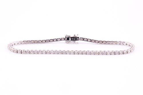 Lot 427 - A diamond line 'tennis' bracelet consisting of...