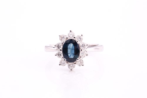 Lot 34 - A sapphire and diamond cluster ring, set with...