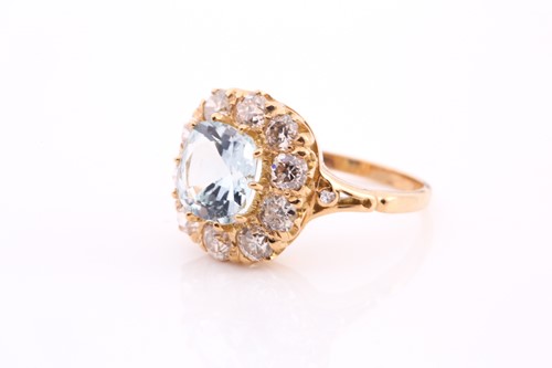 Lot 70 - An aquamarine and diamond cluster ring, set...